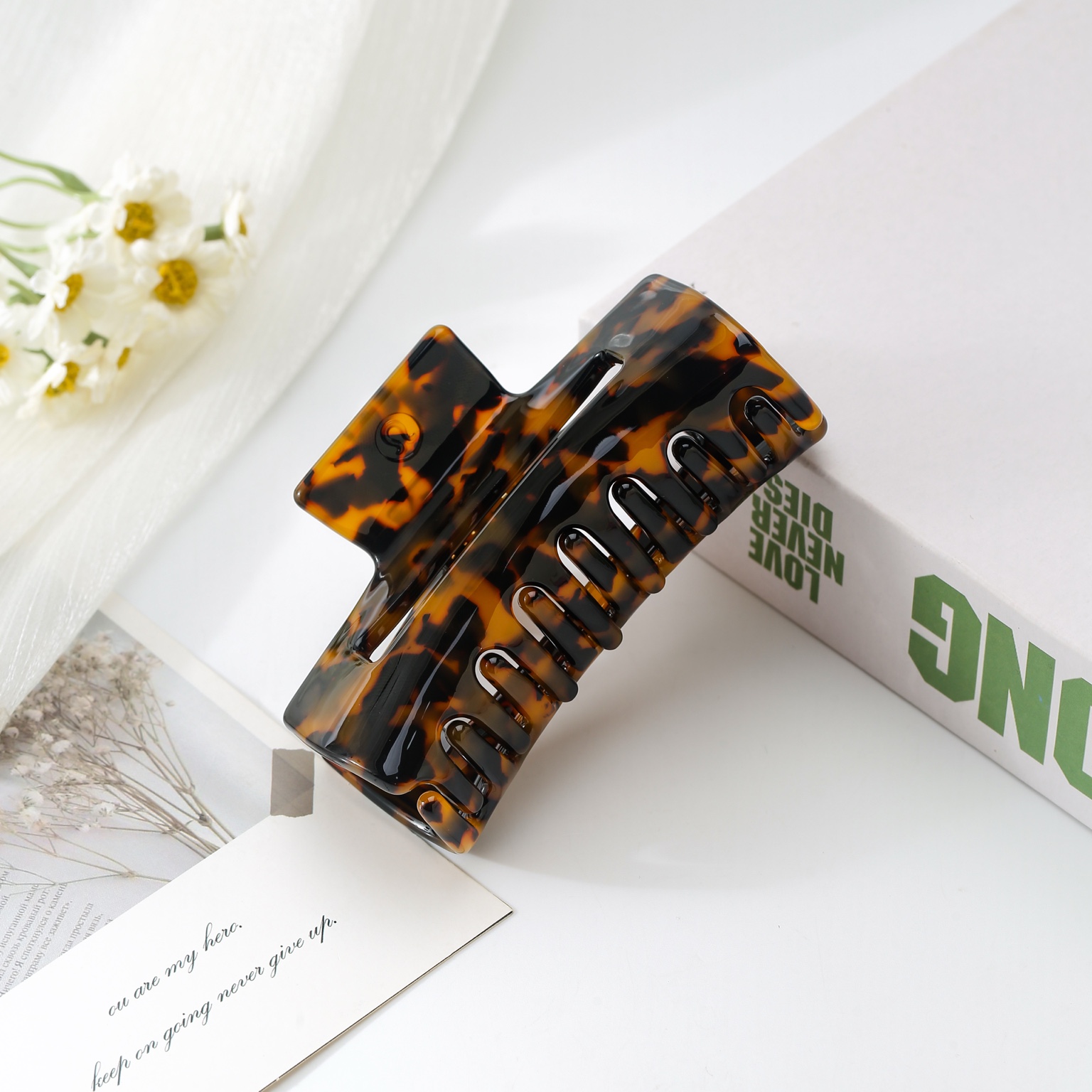 Tortoiseshell claw clip styled on a book